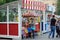 The woman with the child buys popcorn from a street tent in Moscow Zoo.