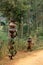 A woman and child carrying pots, Burundi