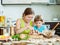 Woman with child cooking fish pelmeni (pelmeni), always together