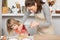 Woman and child cooking stirring an egg in bowl