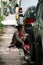 Woman with a child on a curb in Bali, Indonesia.