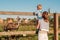 Woman and child at farm looking at ostrich