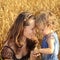 Woman with child in field of wheat