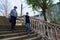 Woman and child girl walks down the street during the day, a pedestrian walkway and buildings with apartments, a residential area