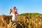 Woman and child in golden ears grain crops field