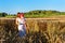 Woman and child in golden ears grain crops field