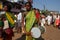 A woman with a child in her arms beats a drum. Street mu celebration of Maha Shivaratri. India, Karnataka, Gokarna. February, 201
