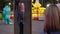 A woman with a child in her arms in the park stands in front of a crooked mirror