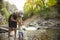 Woman and child hiking across a beautiful scenic mountain river