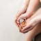 Woman with a child hold hands hearts with euro coins. Family financial training and profitable contributions.