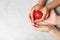 Woman and child holding heart on grey stone background. Donation concept