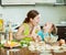 Woman with child making fish dumplings from salmon at domestic