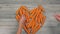 Woman with child puts carrots in the shape of a heart timelapse