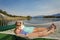 Woman and child relaxing in a hammock on a beautiful Mountain Lake