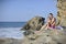 Woman and child on the rocky beach.