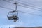 Woman and child on ski lift with view of blue sky