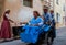 Woman with child in vintage pram  & family  in a vintage three wheeler ,dressed up in old fashioneed clothes   for heritage day