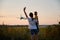 Woman with child waving hand to landing commercial airplane