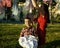 Woman with children in garden hanging laundry outside