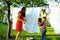 Woman with children in garden hanging laundry outside, playing with cute baby girl toddler, lifestyle people concept