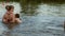 A woman with children are swimming in water outdoors