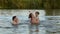 A woman with children are swimming in water outdoors