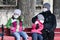 Woman with children wearing protective masks against coronavirus COVID-19 on street in Kyiv, Ukraine on March 31, 2020