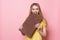 Woman with chocolate smiling. Cute girl holding and eating giant cocoa chocolate bar near pink wall