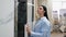 A woman chooses ceramic tiles in a hardware store