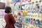 Woman chooses cosmetics at a store.