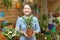 Woman chooses ficus plant (Bonsai)