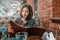 Woman chooses food and drinks from a large menu in a restaurant