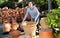 Woman chooses pots clay pots in store warehouse