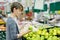 Woman choosing apple at fruit supermarket