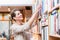 Woman choosing book in bookstore