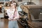 Woman choosing car in the showroom