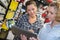 Woman choosing color paint during hardware shopping in home improvement