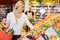 Woman Choosing Fresh Apples In Grocery Store