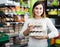 Woman choosing healthy eggs in supermarket