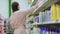 Woman is choosing household cleaning products