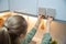 Woman choosing kitchen cabinet materials from laminate samples