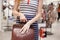 Woman choosing leather backpack at shop