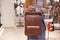 Woman choosing leather backpack at shop