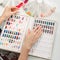 A woman is choosing nail polish in a manicure salon