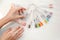 A woman is choosing nail polish in a manicure salon