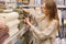 Woman choosing new bath mat to home in household store.