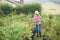 Woman choosing plants and trees at nursery