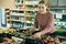 Woman choosing potatoes among different varieties