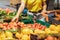 woman choosing red tomatoes from store shelf grocery shopping