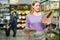 Woman choosing semi-finished frozen pizza